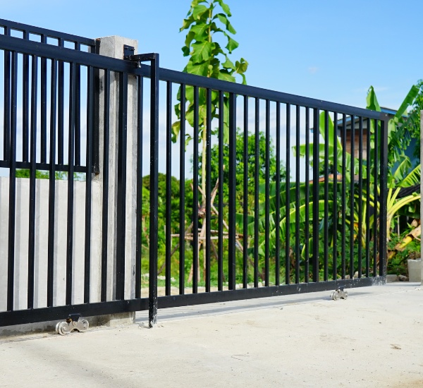 Heavy-duty sliding gate with industrial-grade rollers and motor, typical of large Chatsworth properties