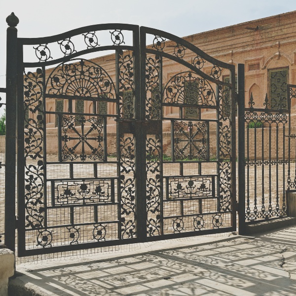 Driveway gate repair technician servicing a gate motor in Los Angeles