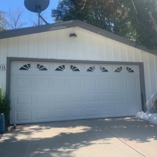 Safety checkup on a tract-home garage door including spring, cable, and sensor testing in Winnetka