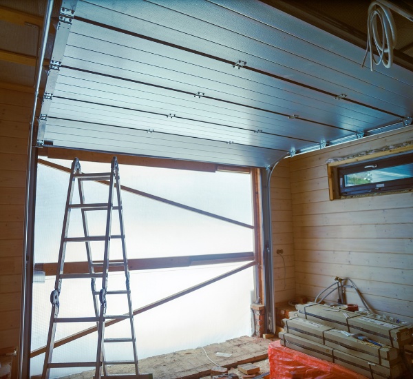 Technician realigning a garage door that came off its track in Los Angeles
