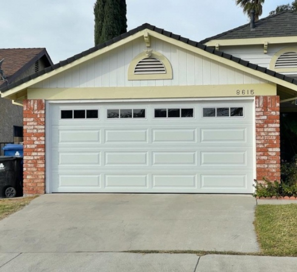 Two-car steel garage door on a typical Reseda tract home serviced by EM Garage Doors