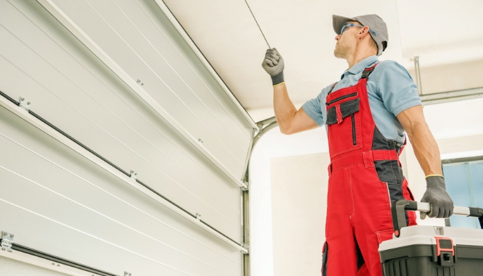 Skilled Technician Repairing a Garage Door Off Track