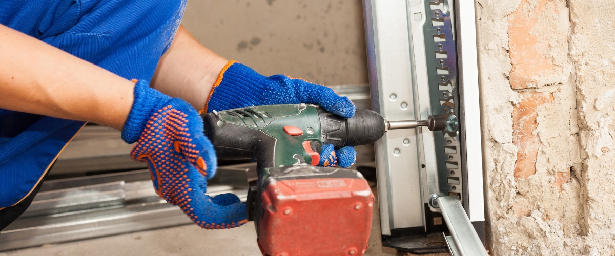 Repairing a broken garage door track to restore functionality.