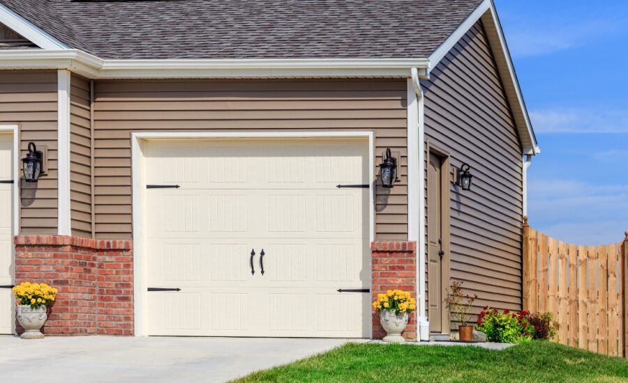 Modern suburban house with a two-car garage and well-maintained landscaping in clear daylight