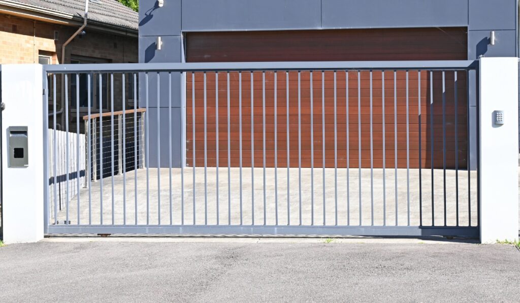 Modern metal gate with automatic access system in a contemporary residential area